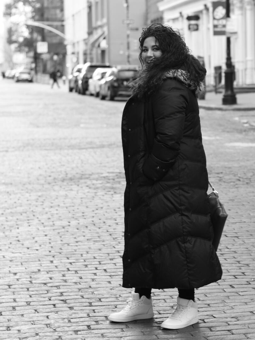 woman in winter puffy coat in soho NY